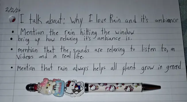 My custom pen with my writing on my red notebook I'll be repurposing for future talking video bullet points.