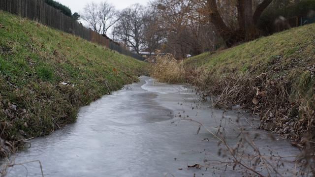 Blick von unten, die Eisfläche im Graben entlang