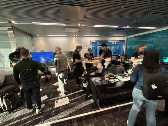 Photo of a booth with lots of people.