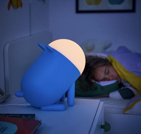 A table lamp in the shape of a chonky blue dog