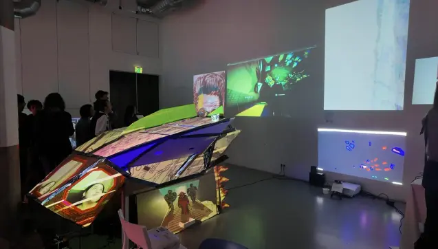 BYOB 2025 with projections on the wall and on a cardboard spaceship.