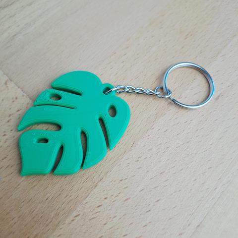 Un porte-clés en forme de feuille de Monstera vert clair.