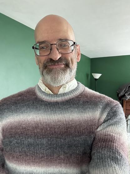 Me, wearing a sweater with bands of white, slate, and maroon blending together on the edges