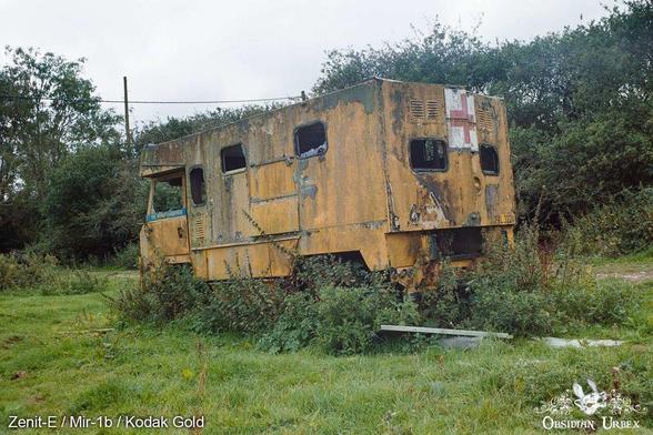 yellow boxy van with medical cross on the back door