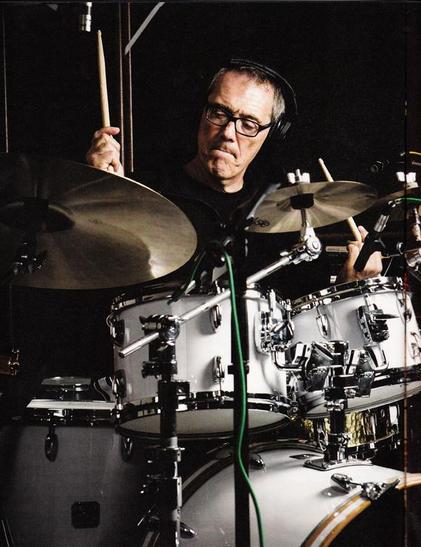 A photo of Vinnie Colauita playing his white Gretsch drum kit.