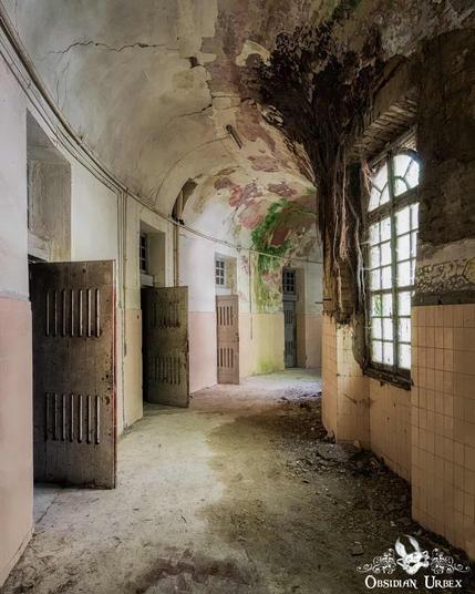 curved corridor with open cell doors