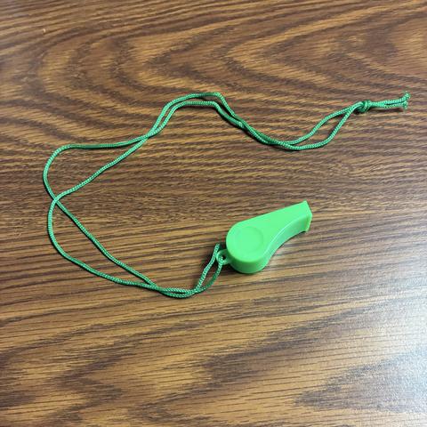 A green plastic whistle