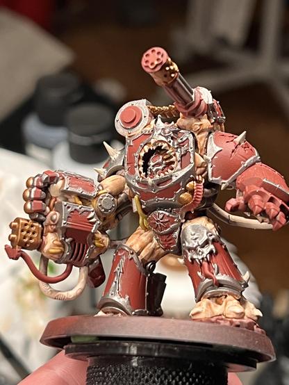 A work in progress paint job of a Chaos Space Marines Obliterator from Warhammer 40K. This unfortunate chap has spent just a wee bit too long in the warp, and as a result his body has erupted in a Cronenburgian mass of flesh, ravaged armor plates, and high powered weaponry~ His paint scheme indicates that he hails from the Word Bearers legion.