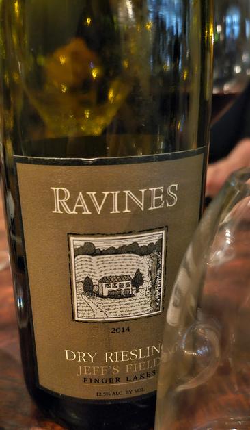 2014 Ravines Riesling "Jeff's Field" from the Finger Lakes, New York. Bottle, glass on table. From Seneca Lake