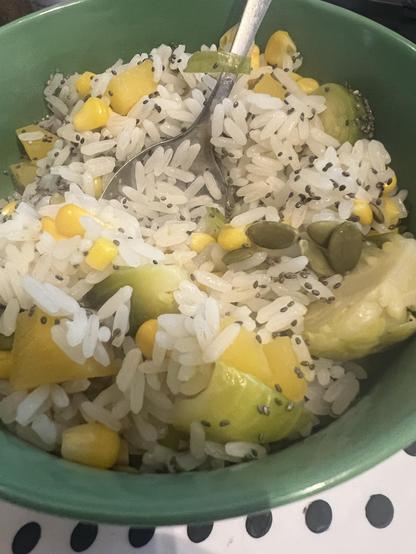 Bowl of cooked white rice, with diced swede, sweetcorn, brussel sprouts, scattered with pumpkin and chia seeds