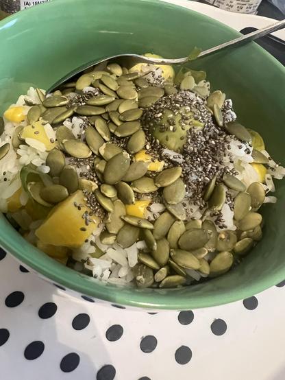 Bowl of cooked white rice, with diced swede, sweetcorn, brussel sprouts, topped  with lots pumpkin and chia seeds before I mixed them in