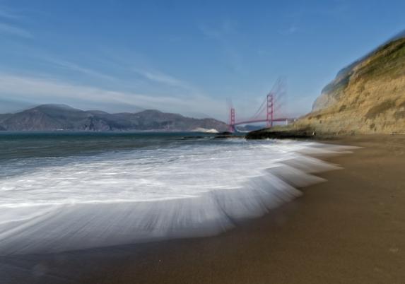 A shot of Baker Beach and the Golden Gate bridge, zoomed during exposure so the waves and bridge radiate out as the zoom happened during half second exposure.