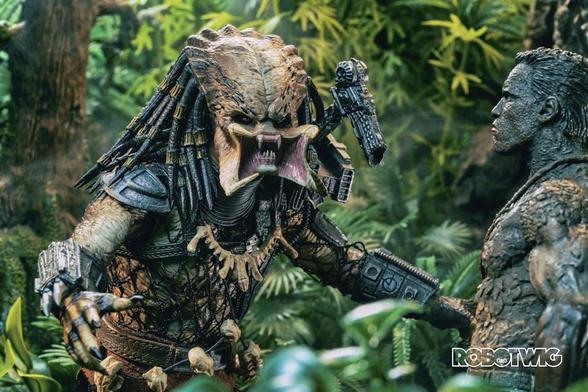 Predator encloses on Dutch with its mouth wide open. Jungle setting. Dutch is covered in mud