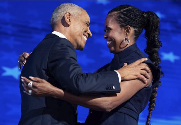 The picture (https://www.elle.com/culture/celebrities/a64907566/michelle-barack-obama-relationship-timeline/) shows Michelle and Barack Obama holding each other in their arms and looking at each other intimately and familiarly.