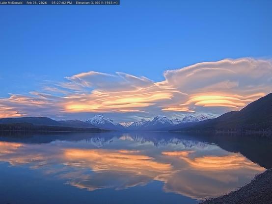 Stunning clouds over Lake McDonald in Glacier National Park today. Colors of orange and yellow, reflected on the lake’s surface, with a line of snow-capped mountains in between. Thanks to the National Park Service and the Glacier National Park Conservancy for providing these beautiful images.