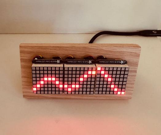 3 8x8 LED panels, mounted on a wood stand, displaying the tide level for a 24 hour period