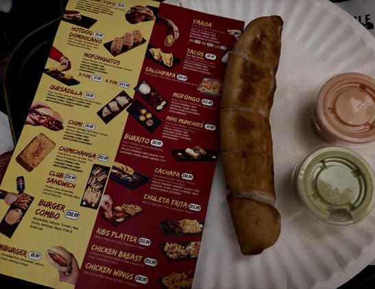 Menu, paper plate with fried cheese stick, two dipping sauces in small ramekins.