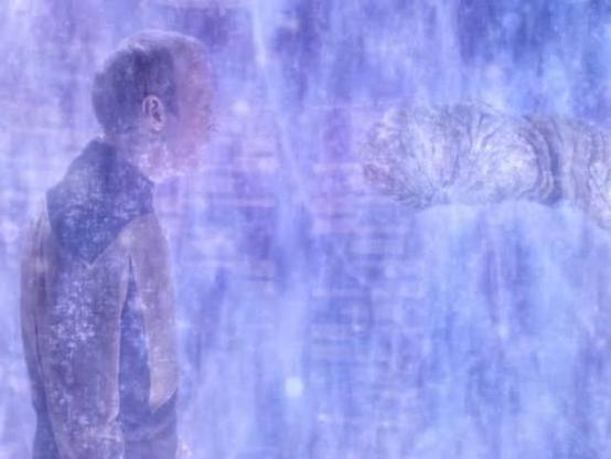 Barclay and a worm like creature in a grainy background representing the process of being transported