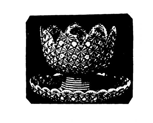 almost crown shaped bowl set on a pedestal, resting in a larger dish. all available surfaces are decorated