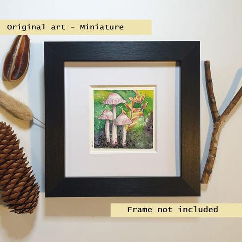 A tiny artwork of pink rosy bonnet mushrooms with leaves and a watercolour background in greens.
An original art work, please note that the frame is not included.
Watercolour and mixed media on white acid free artist watercolour paper.
Approximately 7.5 x 7.5cm, will fit a 3 x 3 inch photo frame.