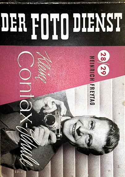 Digital color photo of the cover of a vintage German booklet titled “DER FOTO DIENST,” featuring a black-and-white portrait of a smiling person holding a Contax camera, with the text “Mein Contax-Handbuch,” “Heinrich Freytag,” and “28/29” printed on a purple and black design. (Photo by me, CC-BY-4.0)