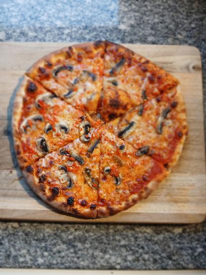Mushroom and habanero pizza on a cutting board.