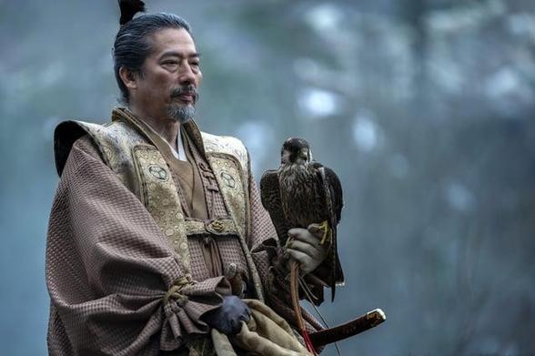 Hiroyuki Sanada as Lord Toranaga holding a falcon on his glove.