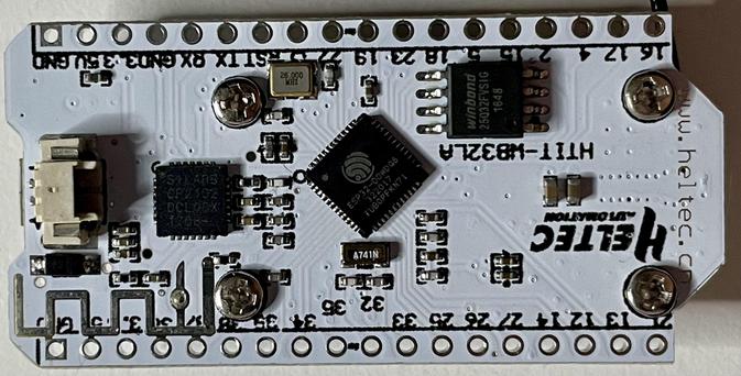The underside of the PCB with a battery (JST) socket, ESP32 microcontroller, CR2102 LoRa radio, and a chip that I’m guessing to be a voltage regulator. There’s also a printed PCB WiFi antenna and four screws that keep the OLED display on the opposite side in place.
