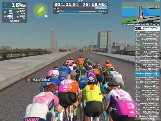 Cyclists avatars ride over a London bridge on Zwift