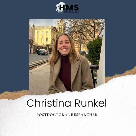 Portrait of Christina Runkel, a postdoctoral researcher, smiling at the camera. She has long hair, is wearing a brown coat and a maroon turtleneck and sits outdoors on a city street, where historic buildings are in the background. The image includes the Her Maths Story logo and her name and title.