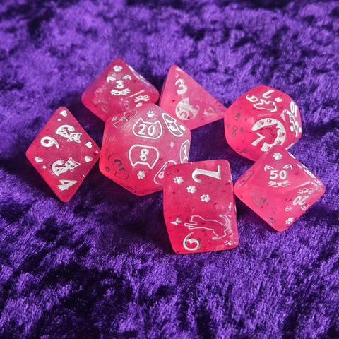 Glittery pink dice with white cat font and motif