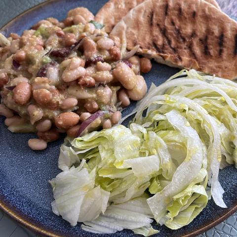 mixed salad of beans and spring onions paired with a crisp iceberg lettuce salad