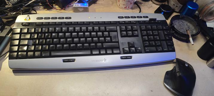 Pic of a desktop with a cherry cymotion linux keyboard.