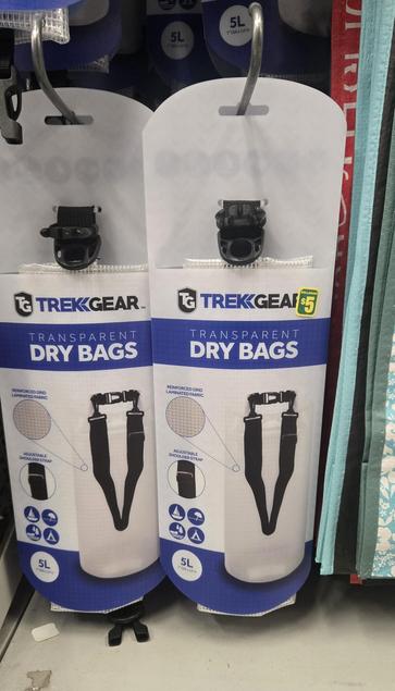 Trekkgear 5L Transparent Dry Bags hanging on 2 racks. The green & yellow price sticker says $5.