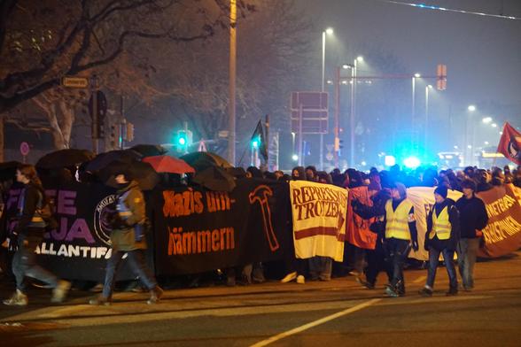 Man sieht auf dem Bild denn Demozug vom im Post benanten Thema. Vorne an dem Zug befundet sich ein Transparent mit der aufschrift ’’FREE MAJA’’ ’’FREE ALL ANTIFAS''. An der Seite ist ein Stransparent mit der aufschrift ’’Nazis um-hämmern’’