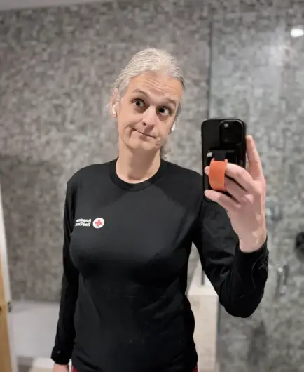 Me about a month ago (Jan 3, 2026) showing off the first size Medium shirt I've acquired in... well, about two decades I suppose. My hair is now gray. 'cause... well, time...