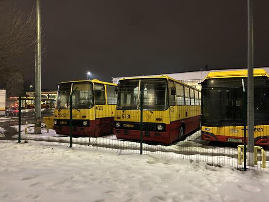 old Ikarus buses at a Warsaw bus depot, marked with special license plates and retrofitted with LED displays