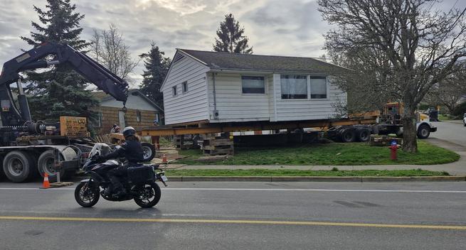 Small single level house on large trailer.