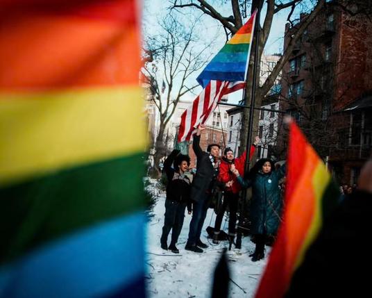 Original pride flag sewn by Dennis Perron with eight stripes Being erected by officials