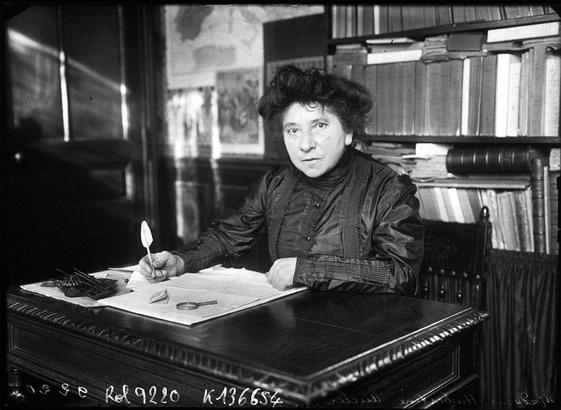 Herbertine Auclert sitting at her editor's desk. She is a white woman with dark hair.
