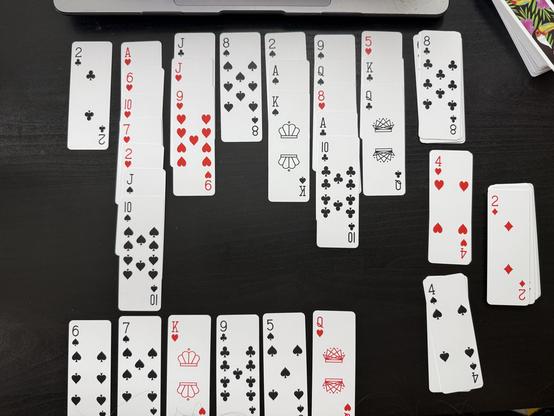 An ongoing game of penguin solitaire played with AirDeck slim playing cards. One of the foundations is completed.