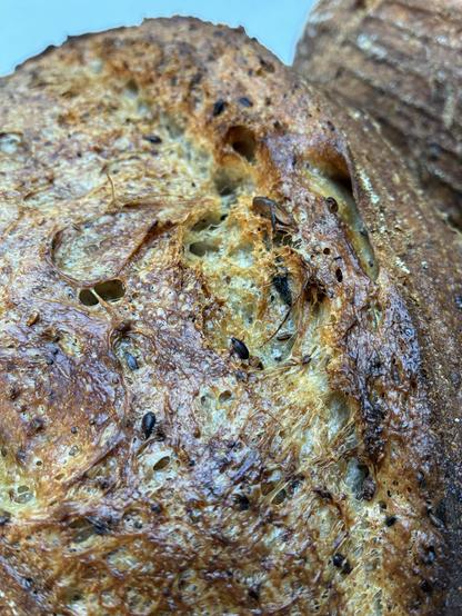 Sourdough batard showing seeds, seaweed and sage.