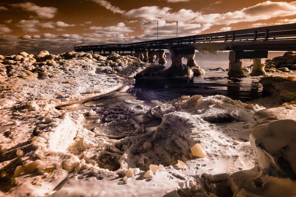 wide view under the bridge showing the ice shelf buildup, like its some surreal ice planet