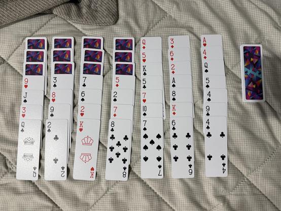 The starting configuration of a game of scorpion solitaire played with slim AirDeck playing cards.