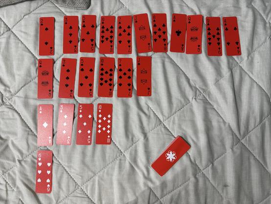 An out-of-moves game of Osmosis solitaire played with slim red AirDeck playing cards.