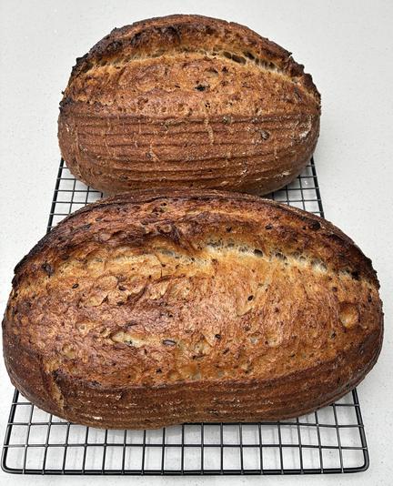 Golden seeded sourdough batard showing seeds, herbs and seaweed.