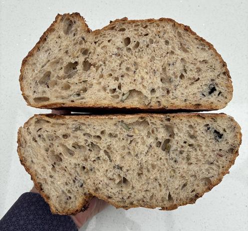 Crumb shot showing the open texture, seeds, herbs and seaweed.