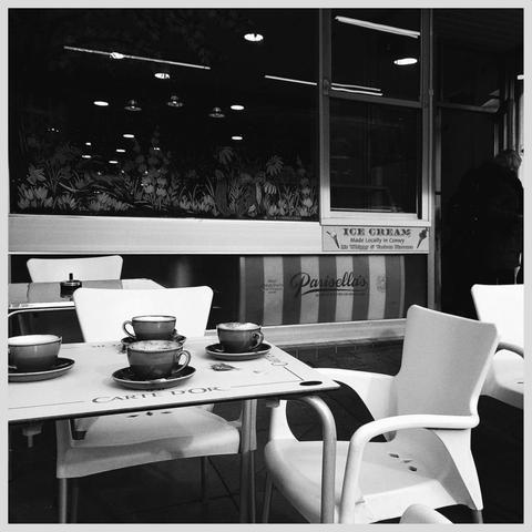 4 empty coffee cups on an outdoor table.