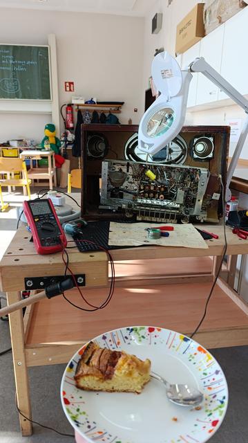 Repair Cafés are also Café not just repair. Pie next to an old tube radio being repaired.