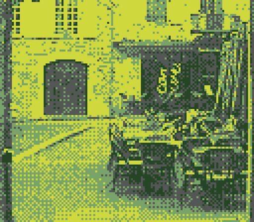 A gb camera picture of a cafe closed for off-season, with chairs folded on top of the tables